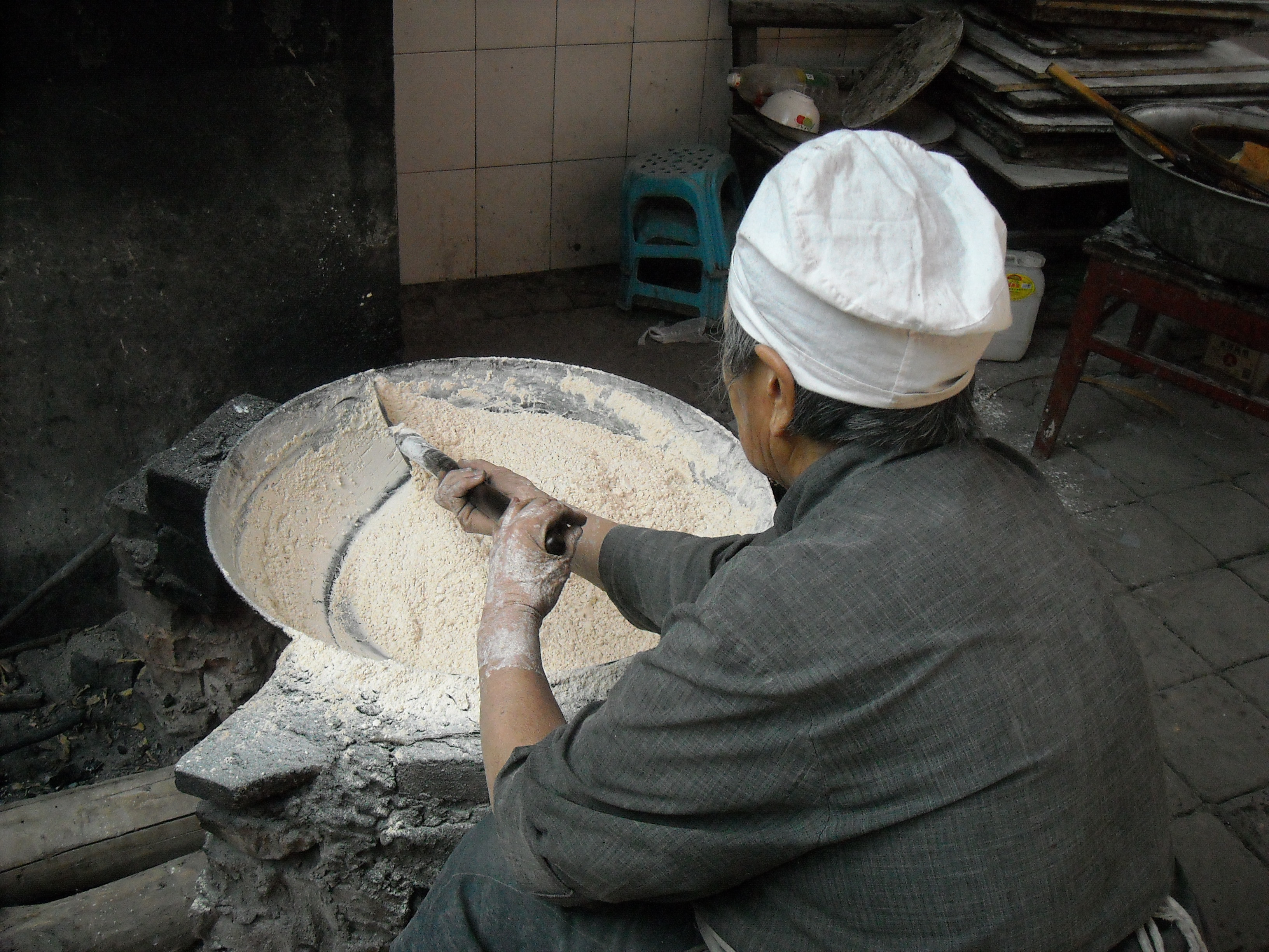 photograph of person over bowl of flour