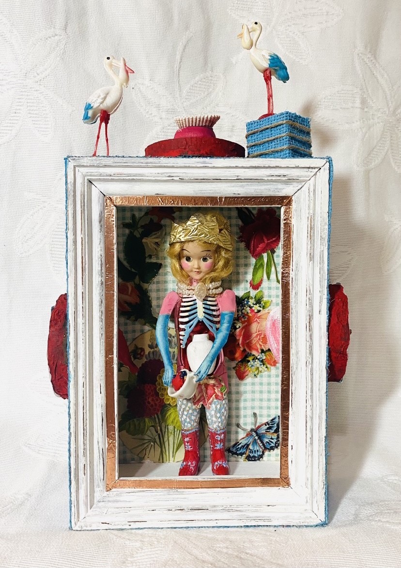 doll inside box with figurines
