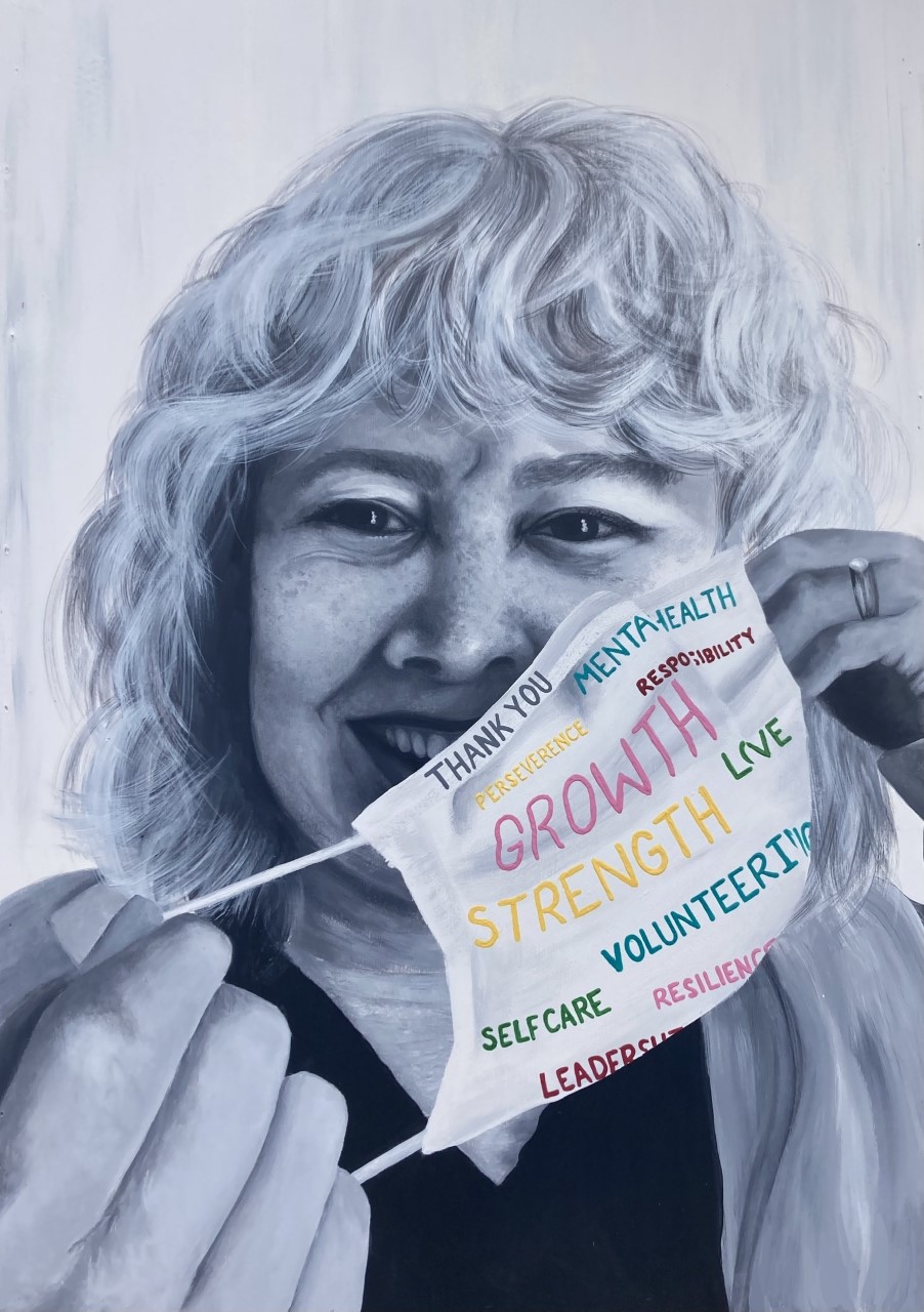 black and white painting of woman pulling off a face mask with positive words in color on it