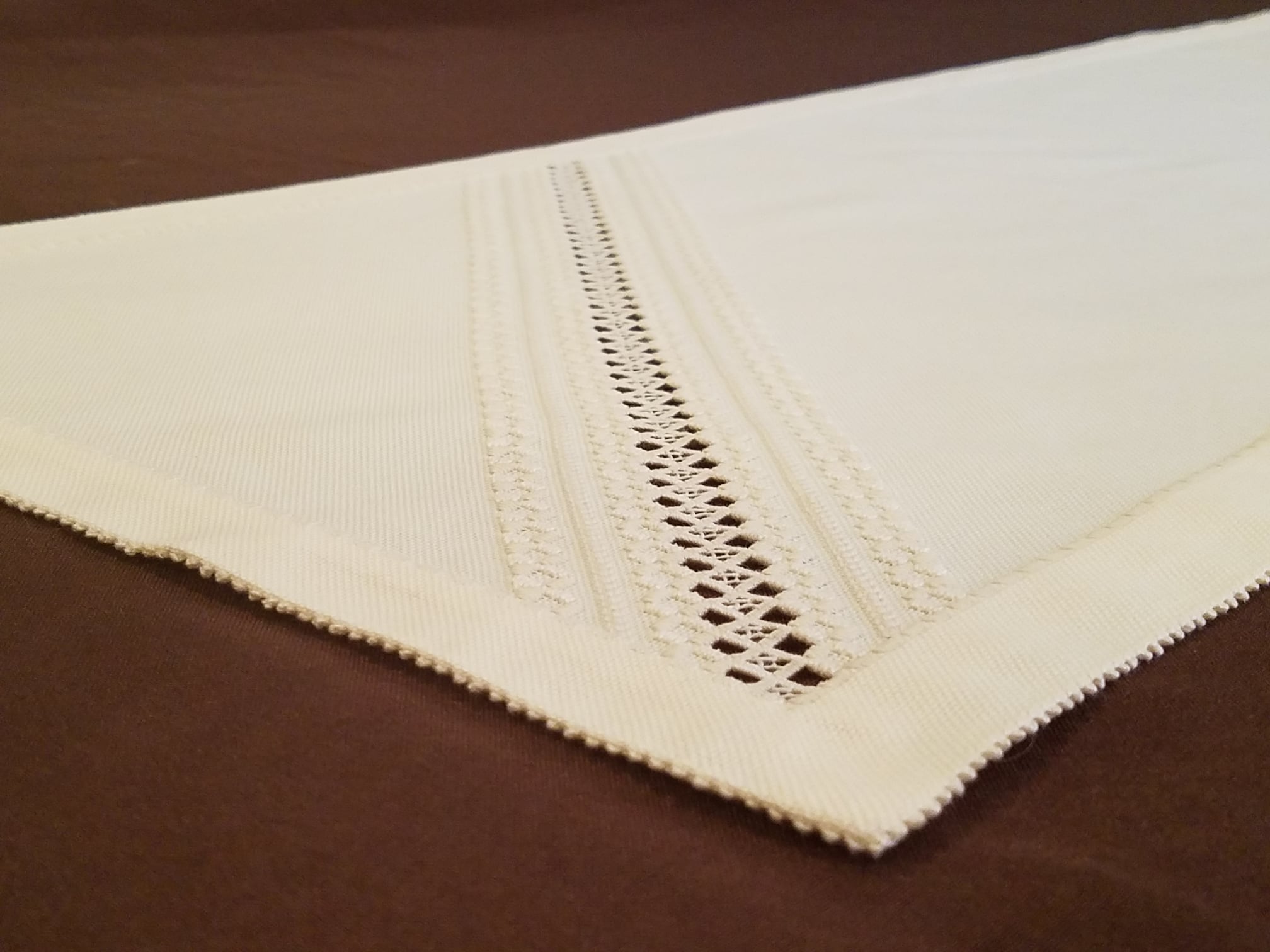 photograph of white embroidered table runner
