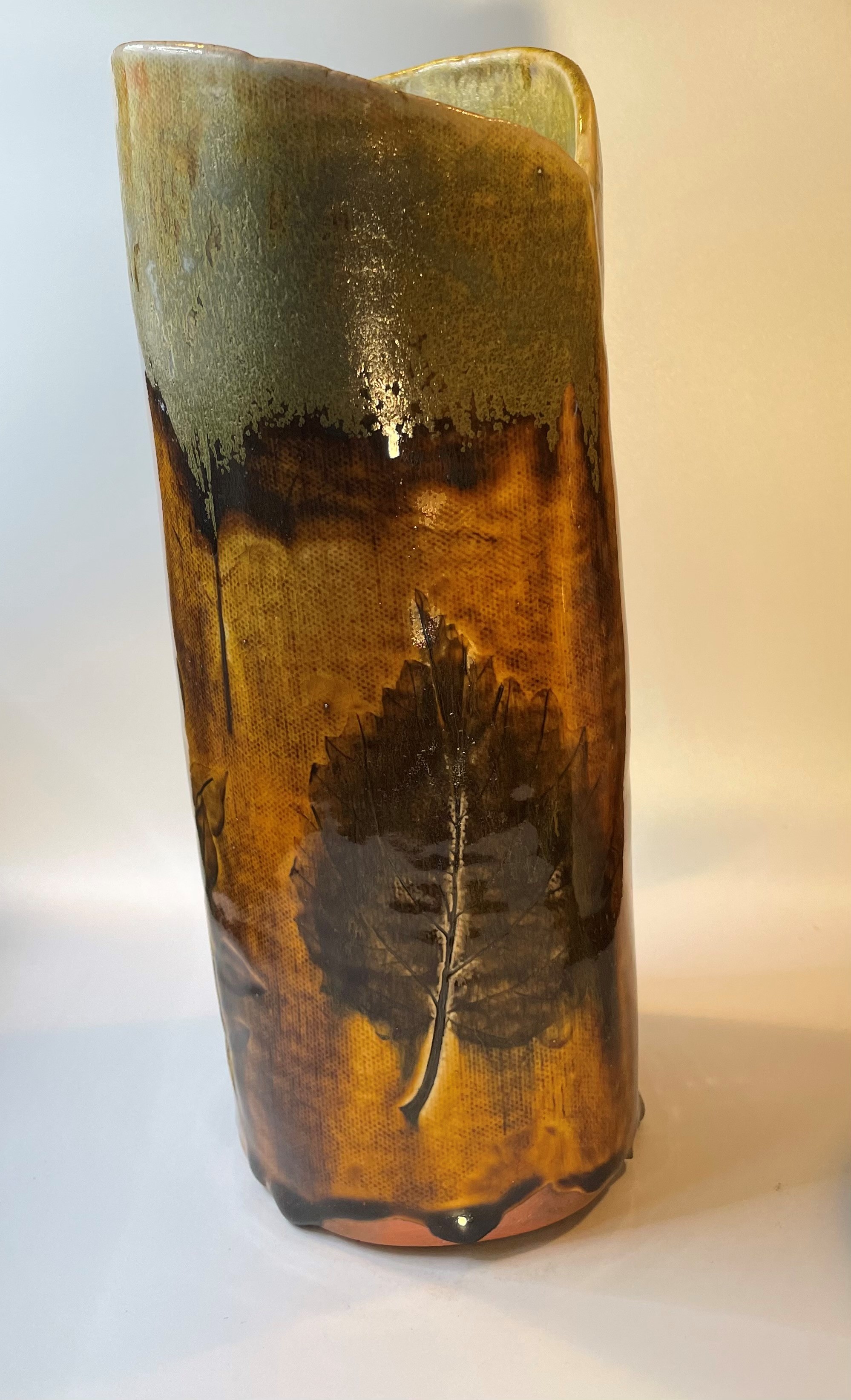 Photograph of tan vase with brown flower imprint