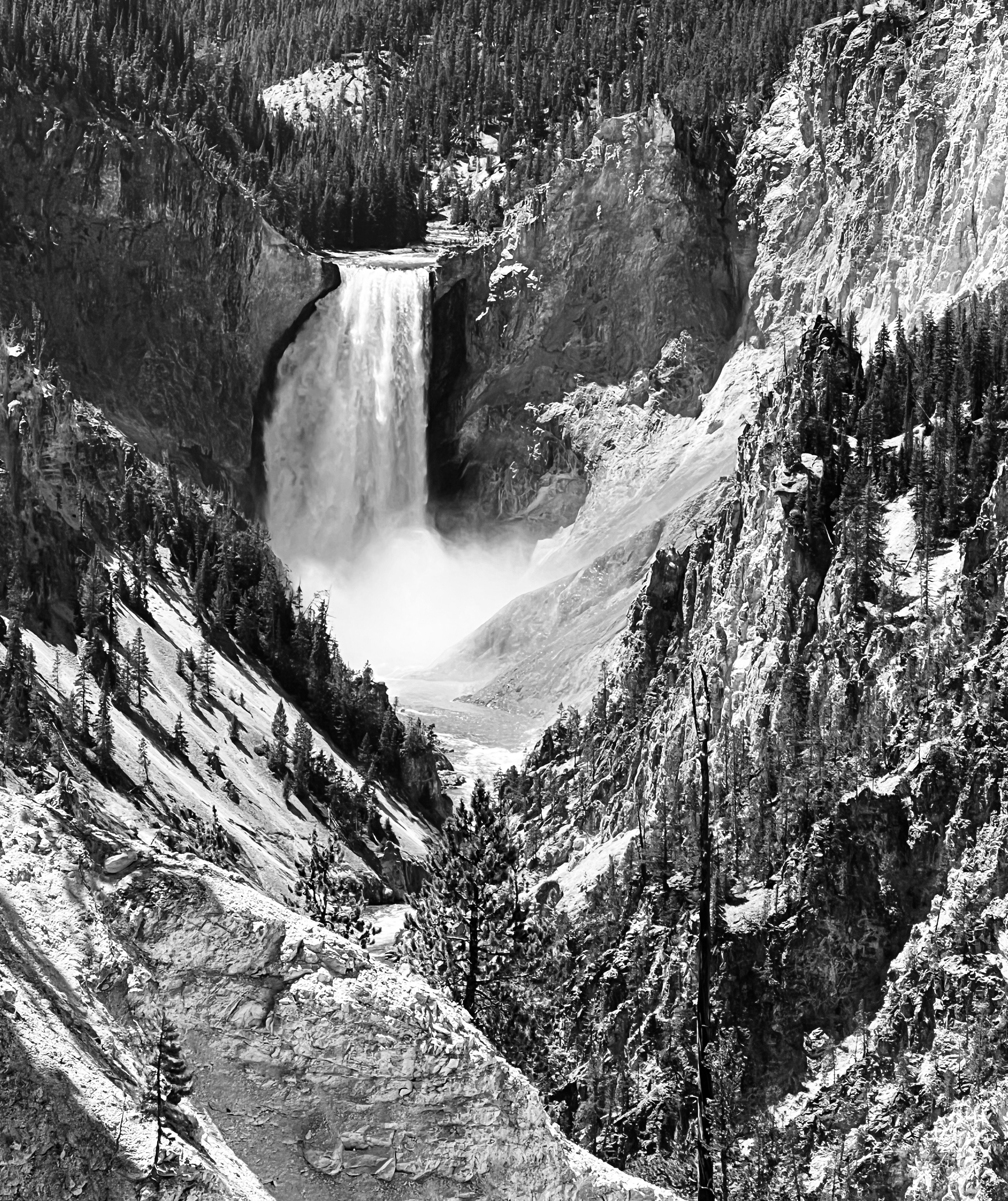 black and white photograph of mountainside with waterfall and trees