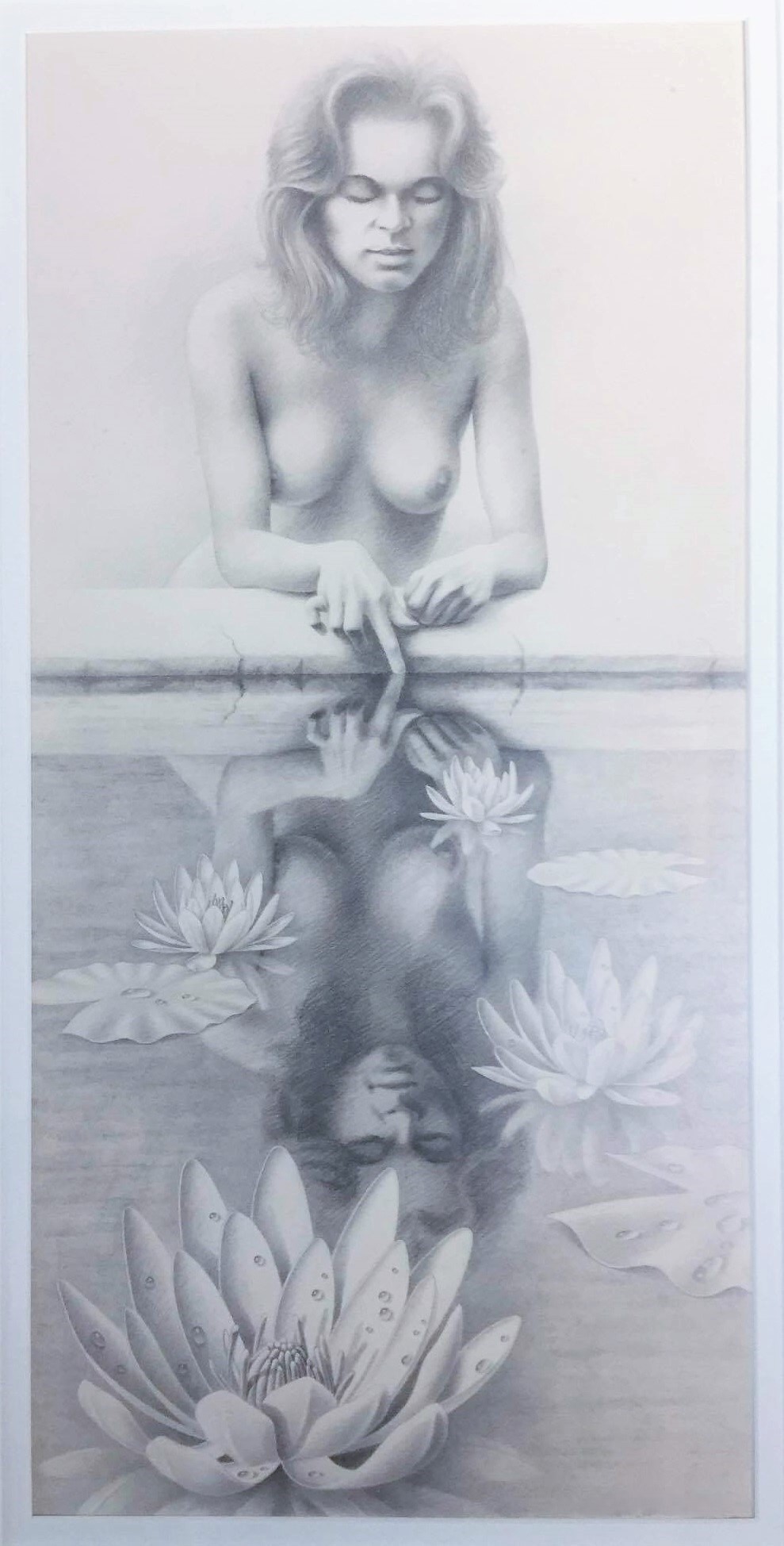 Lifelike black and white drawing of nude woman standing at pool from waist up, sticking her hand in water and looking at her reflection, with water lotuses in the foreground around her reflection