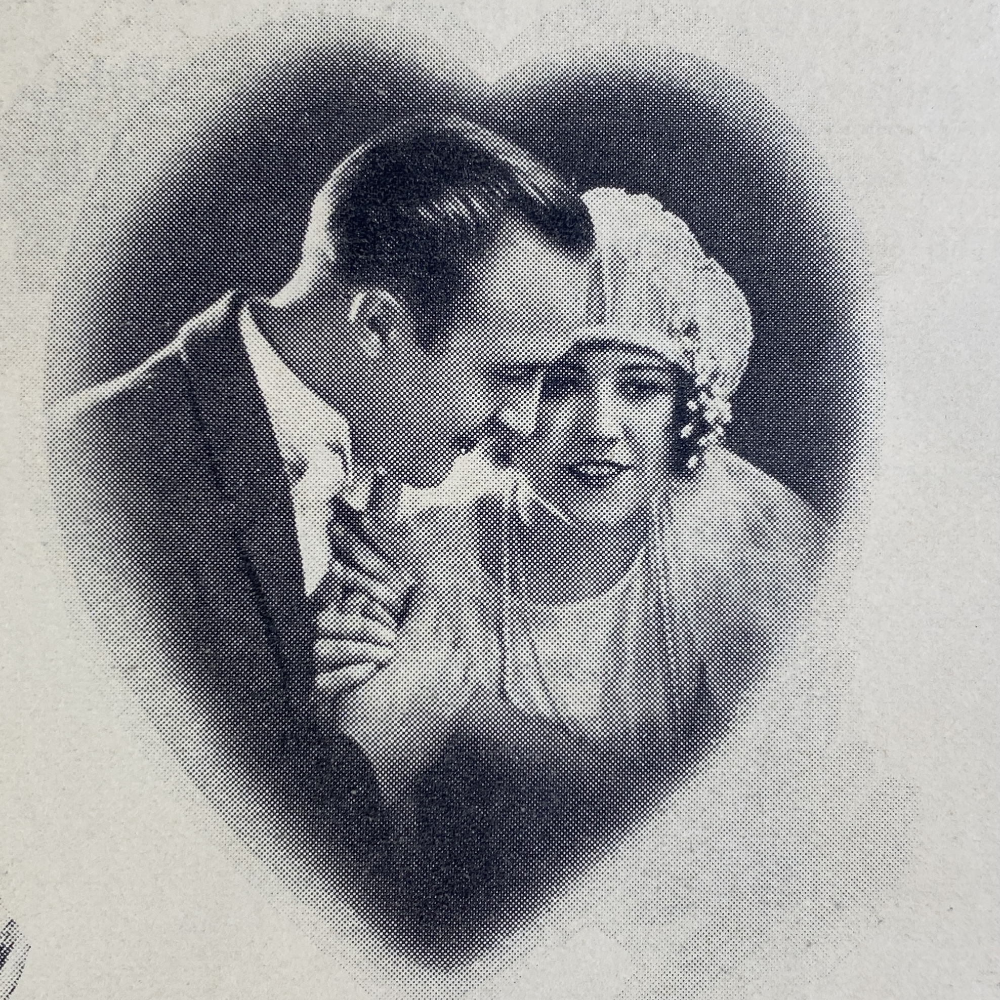 Black and white photograph of a 1920s bride and groom in a heart-shaped vignette